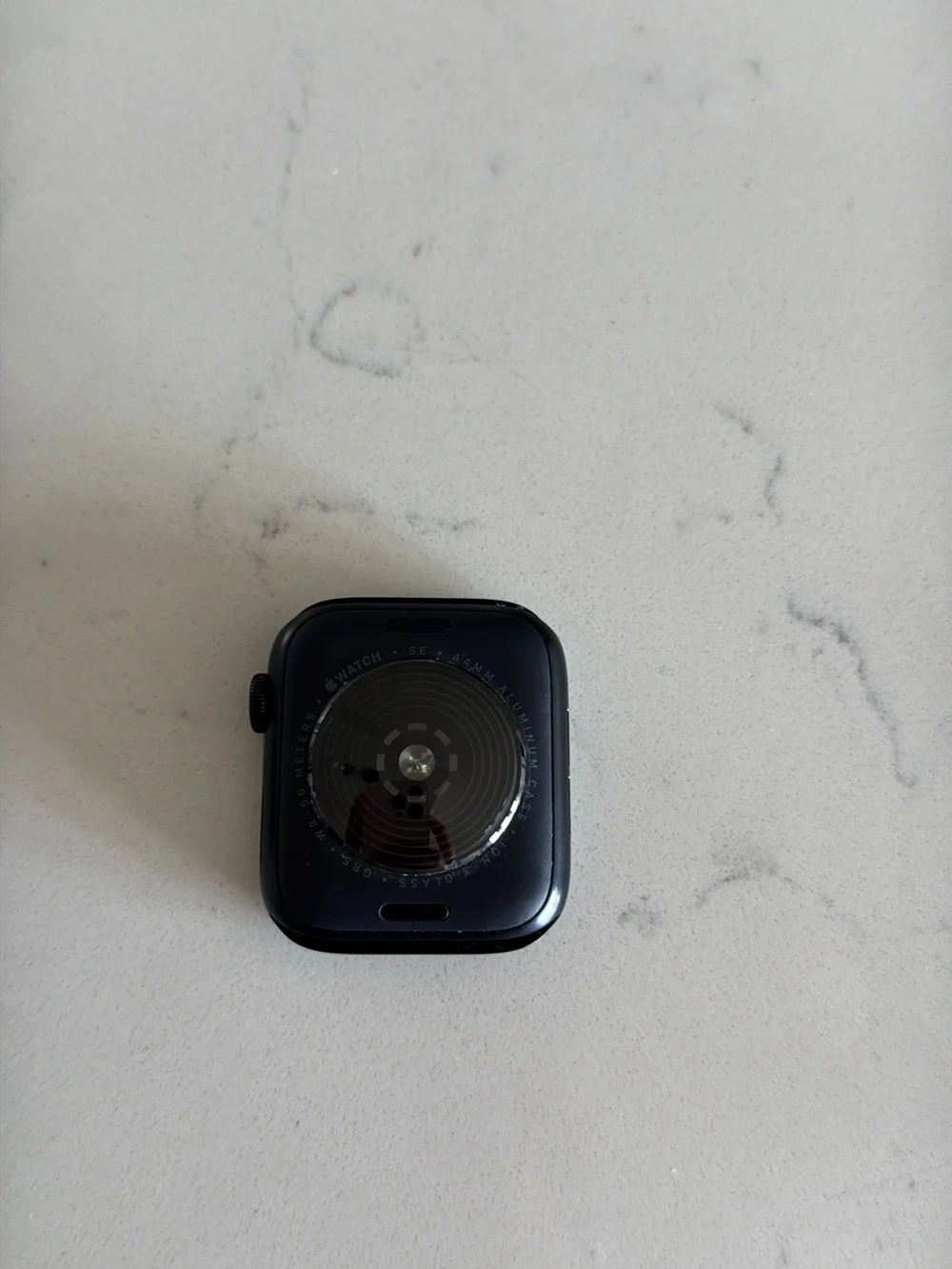 Apple Watch in Black with White Charger Cable